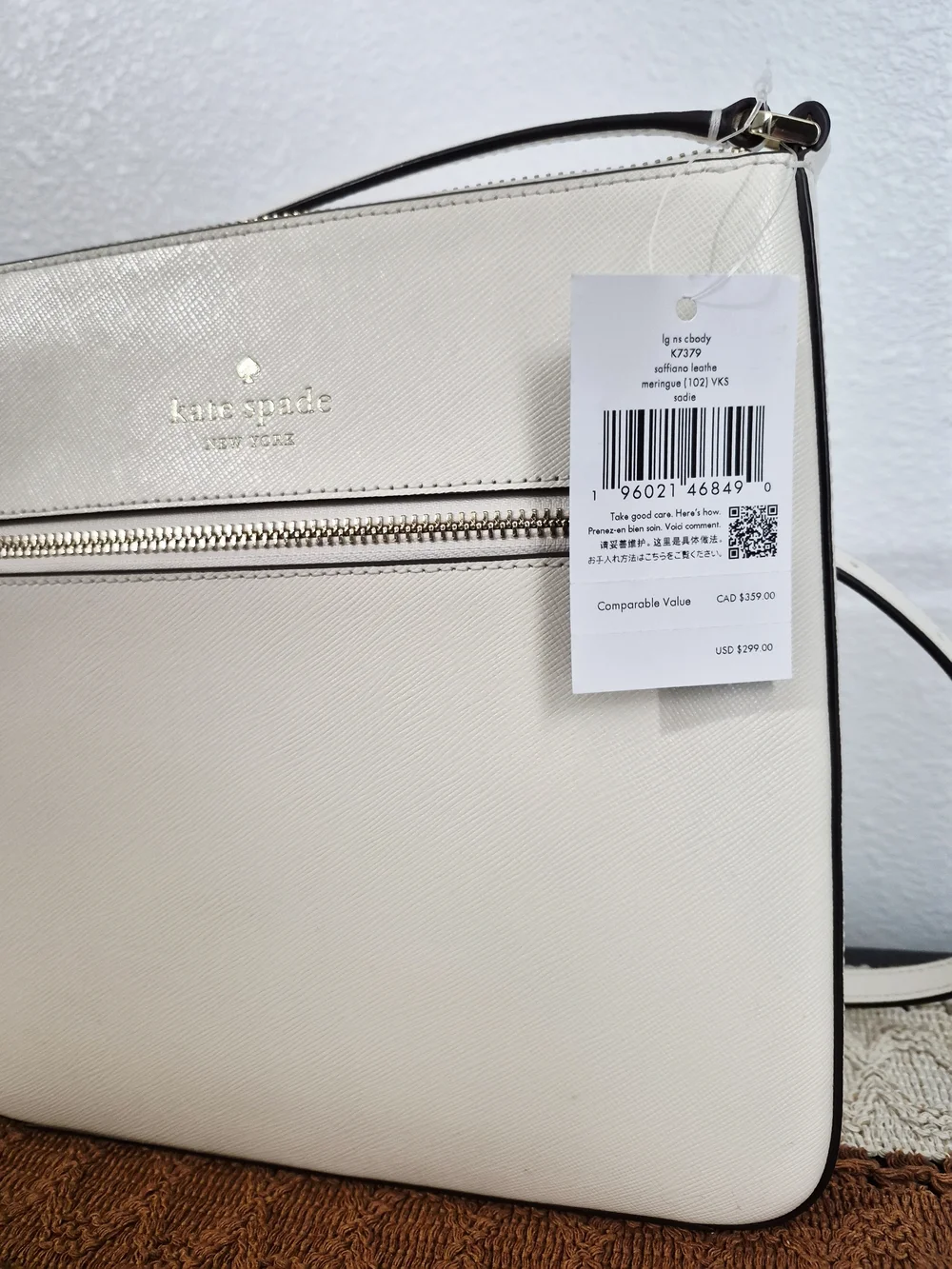 Kate Spade Sadie Cream Saffiano Leather crossbody with front zip